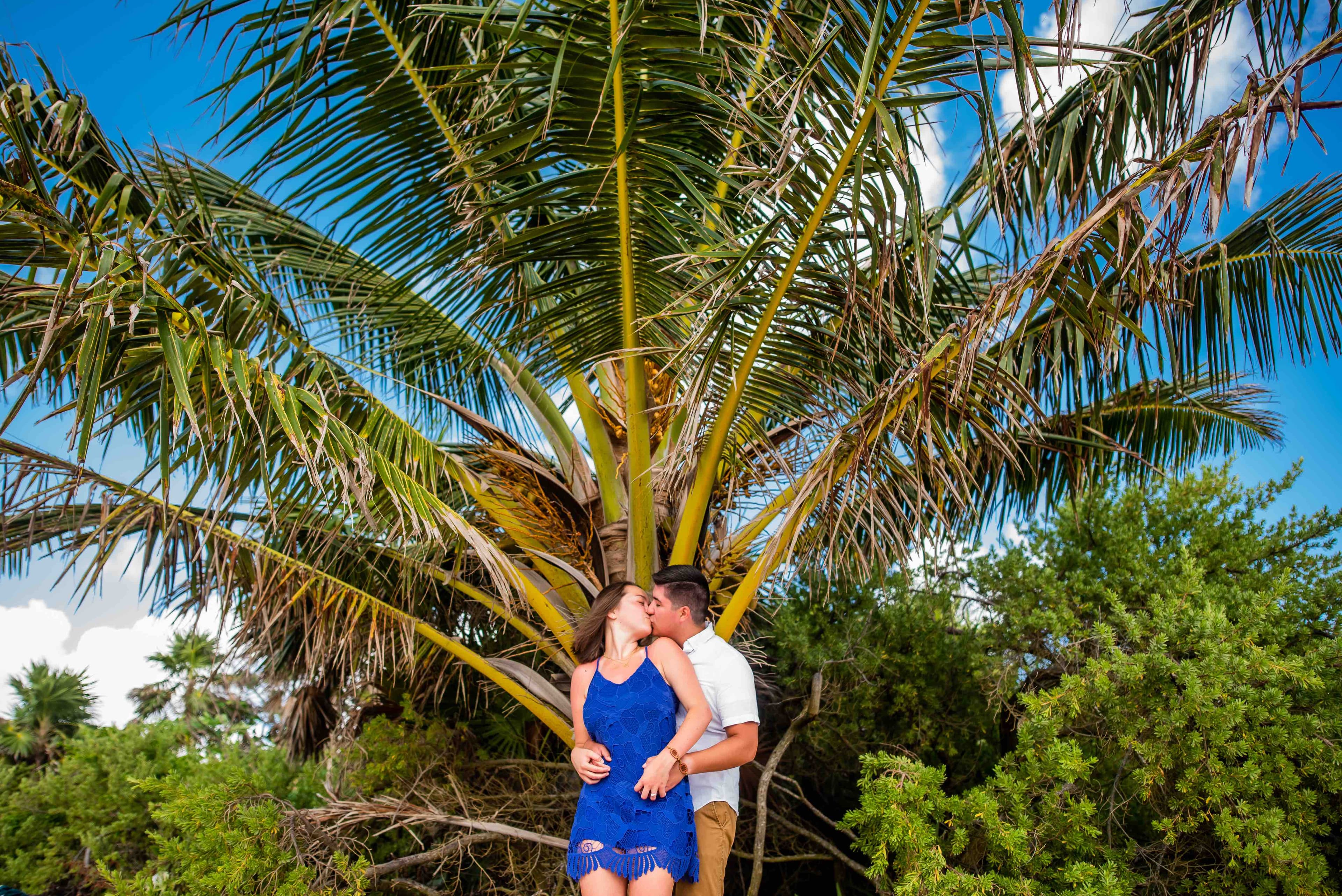 Eli and Hannah in front of greenery in Mexico.